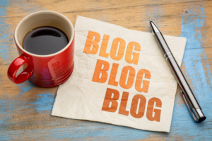 blog, blog, blog - blogging concept on a napkin with cup of espresso coffee