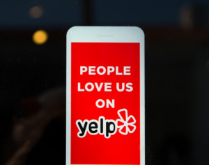 LOS ANGELES, CA/USA - November 11, 2015: Yelp emblem on restaurant exterior. Yelp publishes on-line reviews about businesses.